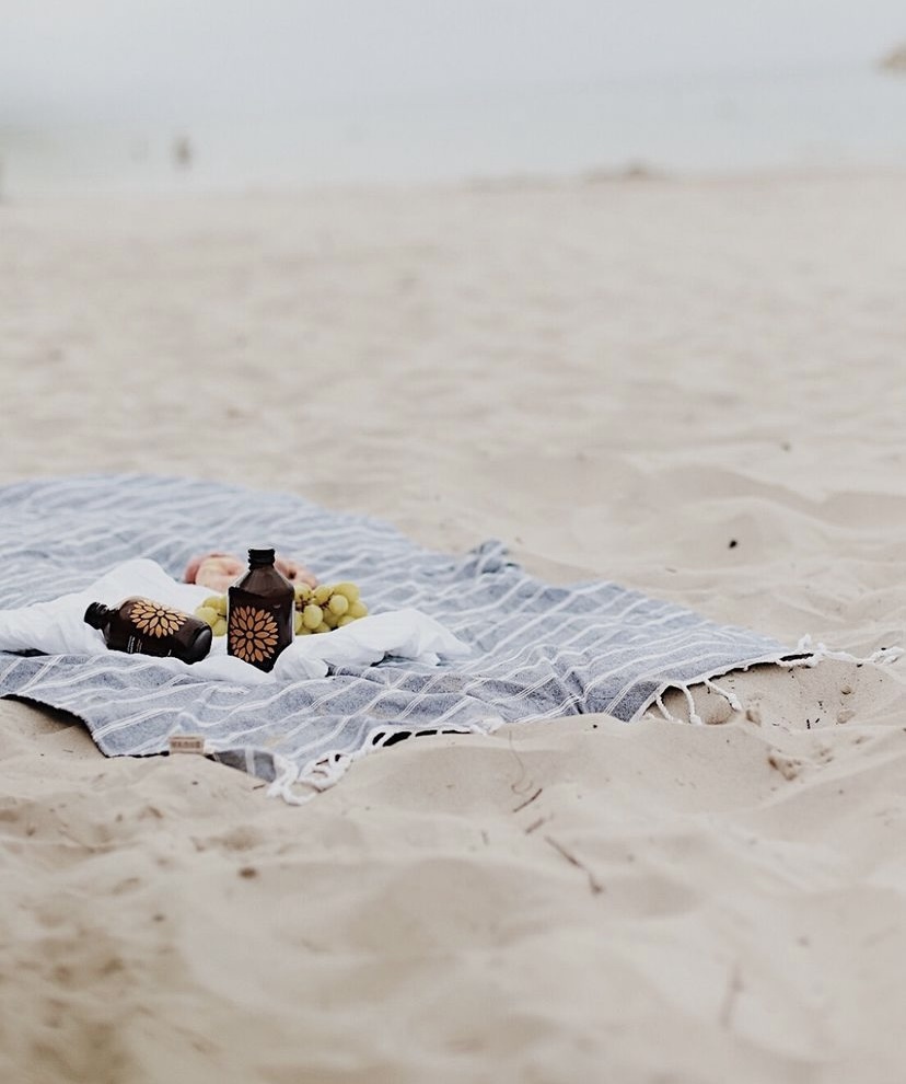 Now O'Clock kombucha on the beach with fruit